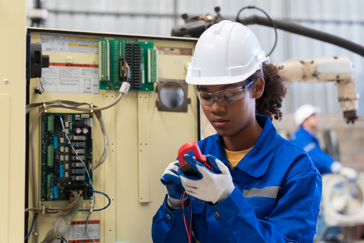 close up of a female engineering student fixing an electrical circuit 